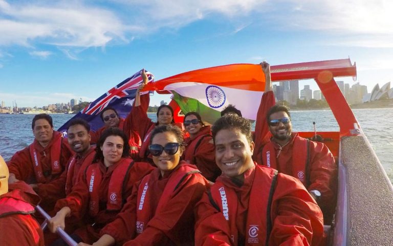 Oz Jet Boating selfie of Indian passengers with flag